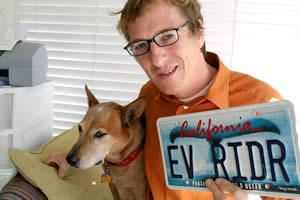 Chris Paine with EV RIDR license plate