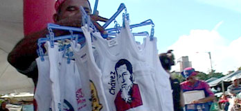 A steet vendor sells t-shirts at an open market in Caracas, Venezuela, February 2006.