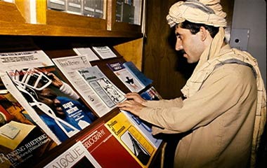 A local man checks out the periodicals at the USIS American Library in Peshawar, Pakistan, circa 1980s.